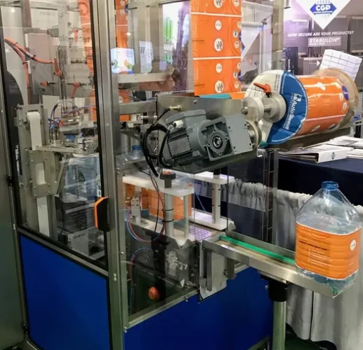 CeltheQ labeling machine with orange label roll at trade show